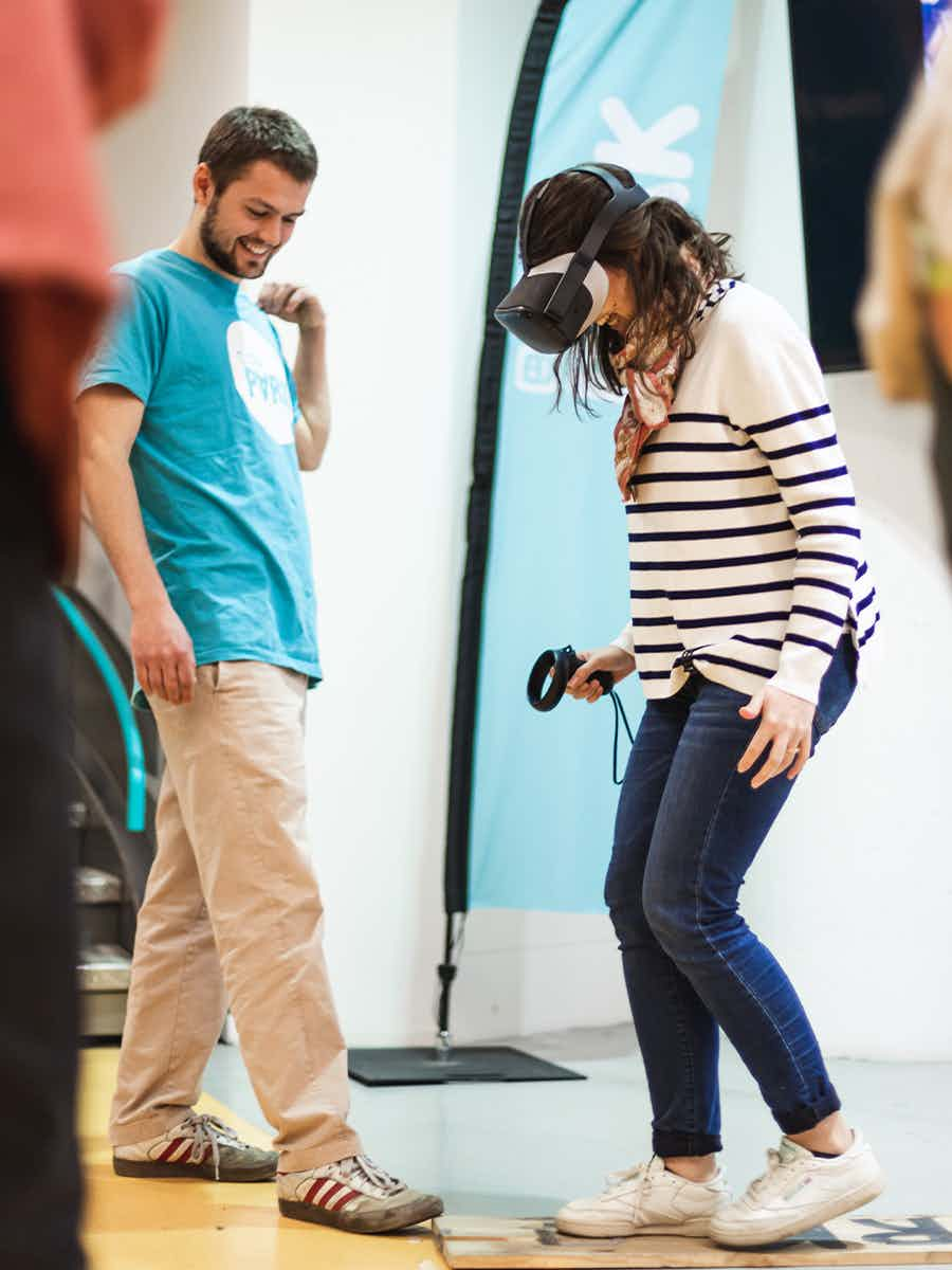 Woman scaredly walking the plank in VR